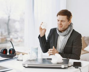 Person at desk working while sick
